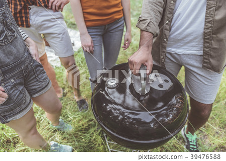 Famished people cooking food in nature Famished people cooking food in nature 39476588