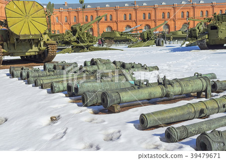 trunks of old guns lie on the snow in courtyard trunks of old guns lie on the snow in courtyard 39479671