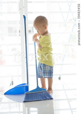 Young kid sweeping floor Young kid sweeping floor 39483456