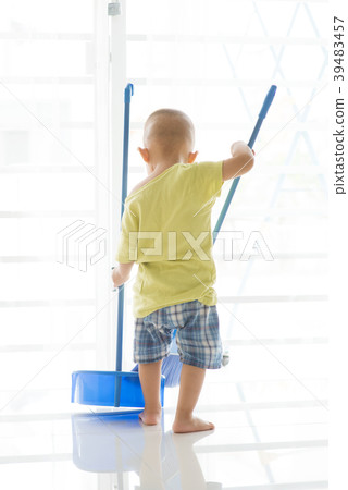 Asian toddler sweeping floor Asian toddler sweeping floor 39483457