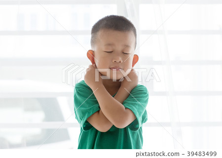 Playful boy pulling ears Playful boy pulling ears 39483499