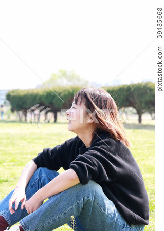 A woman relaxing on the lawn 39485668