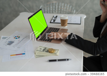 Beautiful young businesswoman working on laptop Beautiful young businesswoman working on laptop 39488165