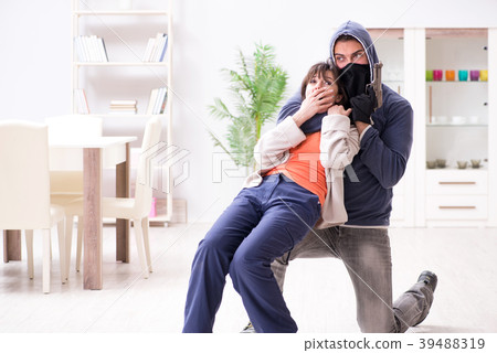 Armed man assaulting young woman at home 39488319