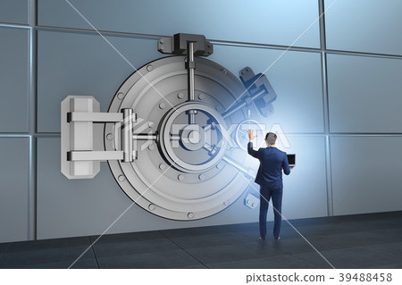 Businessman in front of banking vault door Businessman in front of banking vault door 39488458