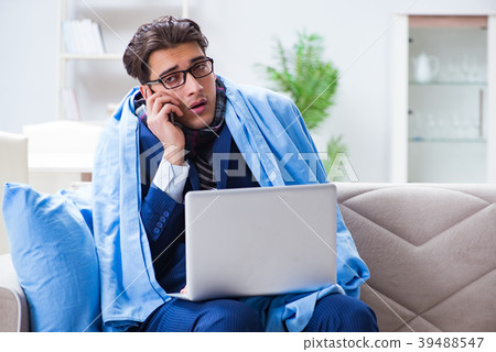 Sick businessman working from home due to flu Sick businessman working from home due to flu 39488547