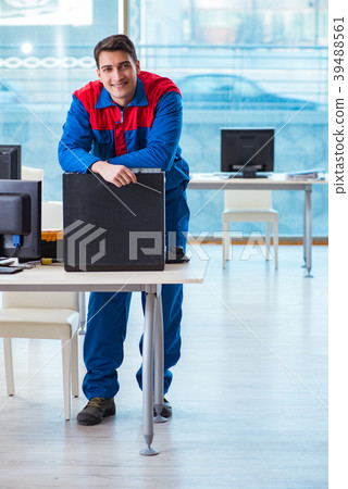Computer technician repairing broken computer in 39488561