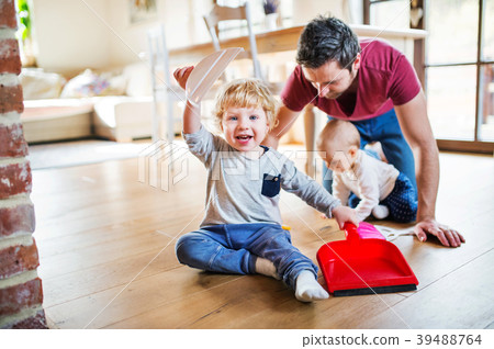 Father and two toddlers with brush and dustpan. 39488764