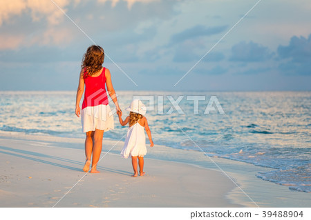 Mother and daughter walking on the beach Mother and daughter walking on the beach 39488904