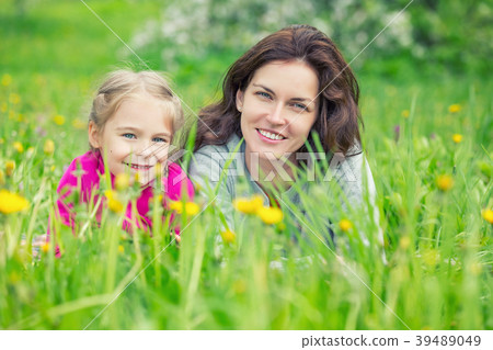 Mother and daughter on green summer meadow 39489049