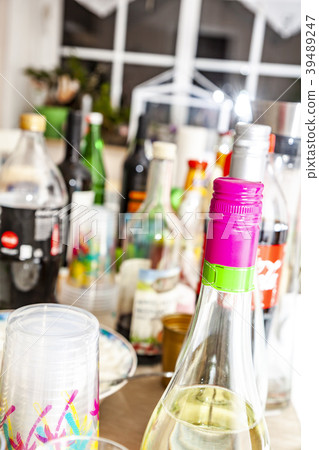 The party table is filled with bottles and cups The party table is filled with bottles and cups 39489247