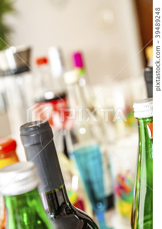 The party table is filled with bottles and cups The party table is filled with bottles and cups 39489248