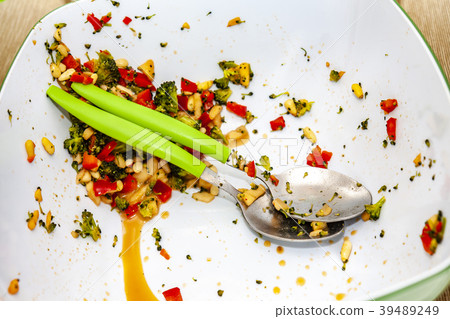 Used plate with salad and cutlery 39489249