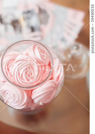 cakes in a vase on the buffet. 39490038