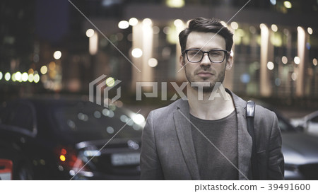 A closeup of a bearded man on the street at night A closeup of a bearded man on the street at night 39491600
