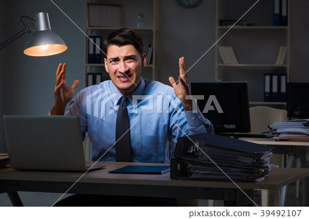 Employee working late at night at important report 39492107