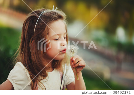 little girl with dandelion in park little girl with dandelion in park 39492371