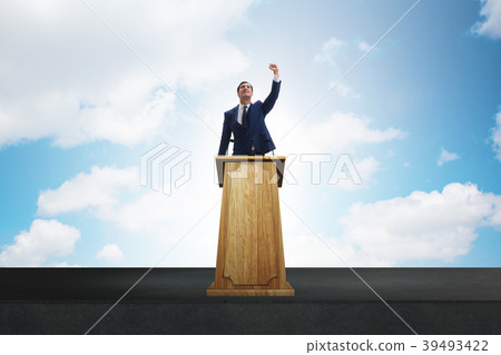 Man businessman making speech at rostrum in Man businessman making speech at rostrum in 39493422