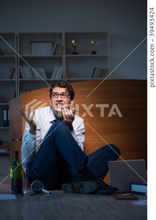 Stressed businessman working overtime in Stressed businessman working overtime in 39493424