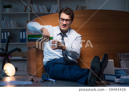 Stressed businessman working overtime in Stressed businessman working overtime in 39493426