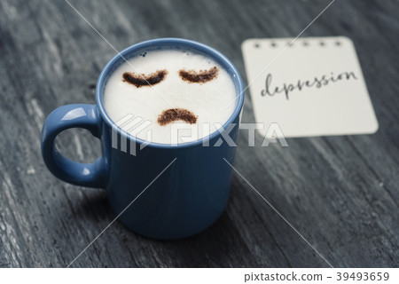 cup of cappuccino with a sad face. 39493659