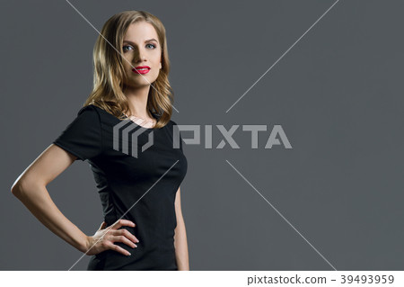 Elegant young business woman blond in black dress Elegant young business woman blond in black dress 39493959