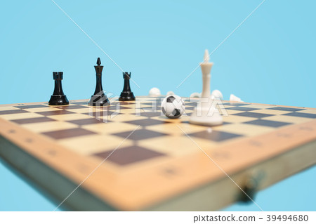 soccer ball of chess pieces on the board soccer ball of chess pieces on the board 39494680