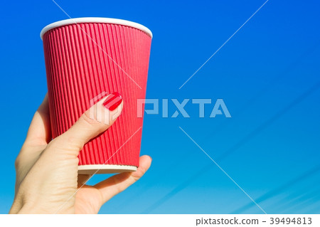 Red paper glass in female hand 39494813