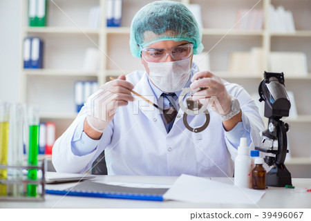 Criminologist police chemist looking at crime 39496067