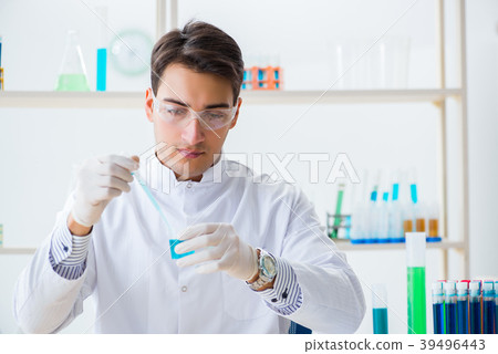 Young chemist student working in lab on chemicals 39496443