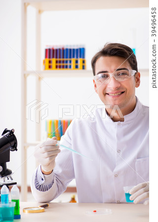 Young chemist student working in lab on chemicals Young chemist student working in lab on chemicals 39496458