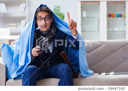 Employee suffering from flue playing computer game Employee suffering from flue playing computer game 39497160