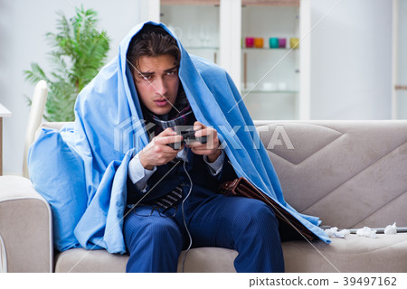 Employee suffering from flue playing computer game Employee suffering from flue playing computer game 39497162