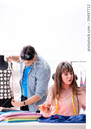 Male tailor with female student in workshop Male tailor with female student in workshop 39497712
