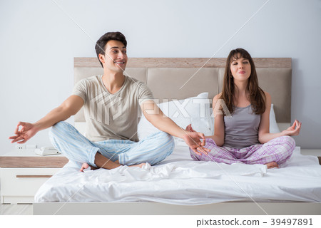 Young family meditating in the bed bedroom Young family meditating in the bed bedroom 39497891