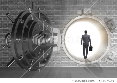 Businessman in front of banking vault door Businessman in front of banking vault door 39497985