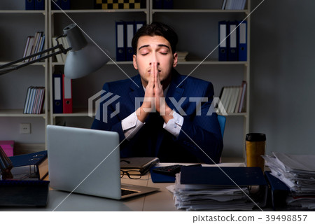 Employee working late to finish important 39498857