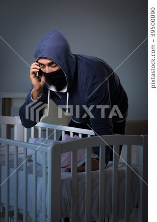 Criminal stealing baby in human child traficking Criminal stealing baby in human child traficking 39500090