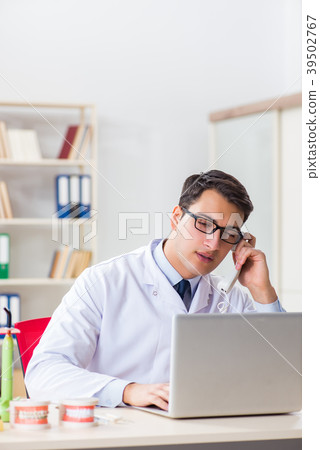 Young dentist working in the dentistry hospital Young dentist working in the dentistry hospital 39502767