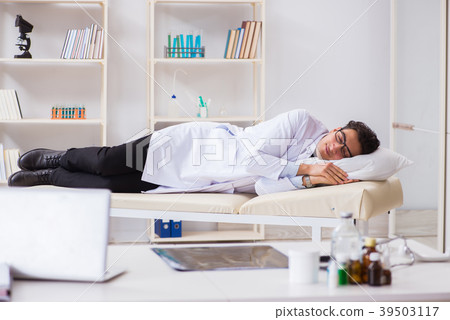 Doctor relaxing after complex surgery in hospital Doctor relaxing after complex surgery in hospital 39503117