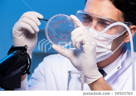 Doctor researching new virus in lab at night Doctor researching new virus in lab at night 39503763
