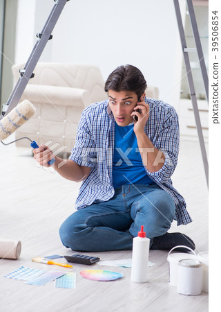 Young man overspending his budget in refurbishment Young man overspending his budget in refurbishment 39506854