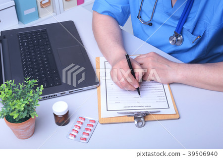 Close-up view of female doctor's hands filling Close-up view of female doctor's hands filling 39506940