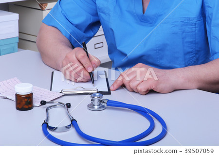 Close-up view of female doctor's hands filling 39507059