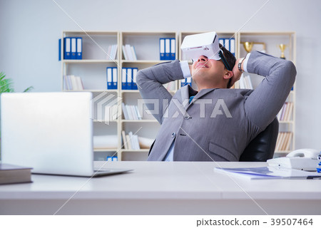 Businessman with virtual reality glasses in modern 39507464