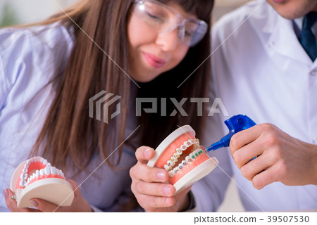 Dentist explaining brackets ligature setting Dentist explaining brackets ligature setting 39507530