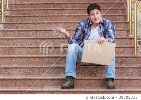 Young man begging money on the street Young man begging money on the street 39508315