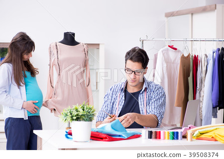 Pregnant woman visiting tailor for new clothing Pregnant woman visiting tailor for new clothing 39508374