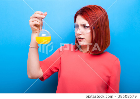 Redhair nerd with a flask of yellow liquid in her Redhair nerd with a flask of yellow liquid in her 39508579