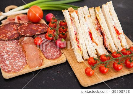 Club sandwiches next to cherry tomatoes, radish Club sandwiches next to cherry tomatoes, radish 39508738